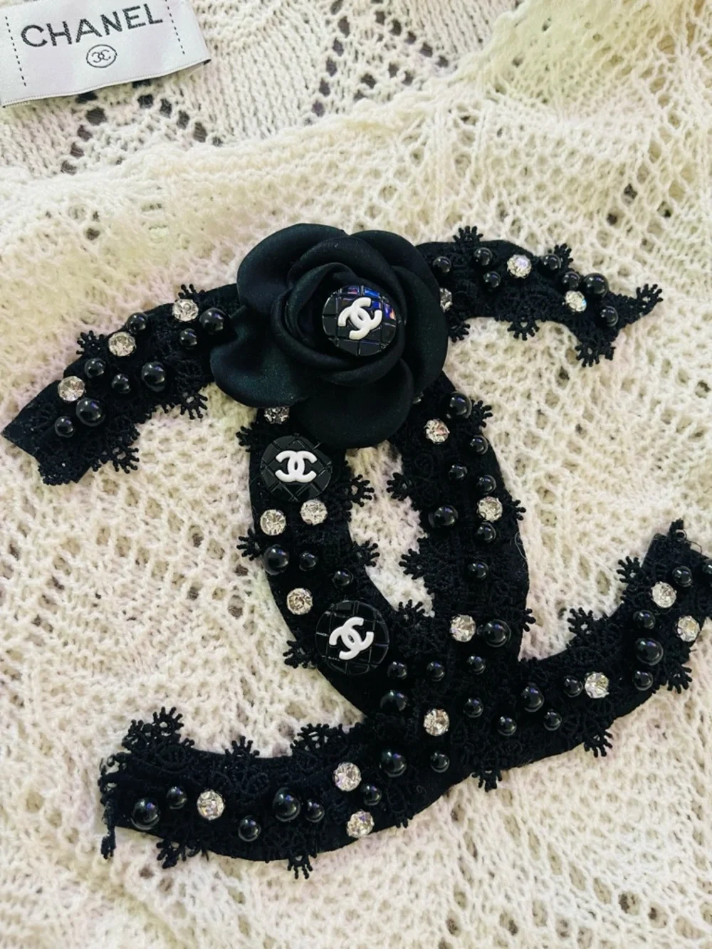 CHANEL Cream Openwork Knit Top with Black CC Appliqué SIZE S